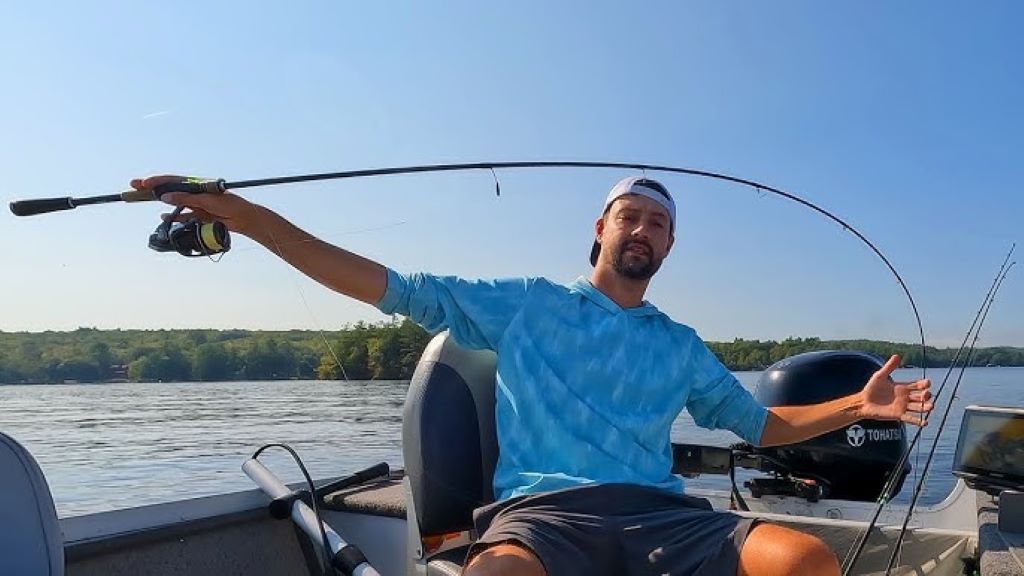 Lake trout fishing setup showing rod, reel, spoons, and jigs on boat deck in small lake